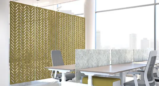 Large rectangular hanging acoustic panels in a mustard yellow with a herringbone cutout pattern suspended above modern benching workstations with white tops in a bright open office. Additionally ideal as room dividers for controlling noise and improving focus in busy collaborative environments.