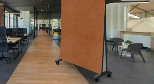 Mobile acoustic room dividers with thick fabric-wrapped panels on locking casters forming flexible quiet pods around seating groups in a contemporary open office. Excellent for creating on-demand private workspaces.