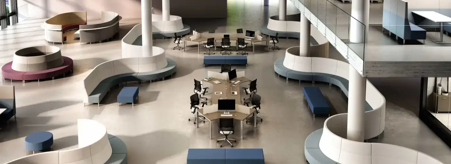 HERO: areial view of dogbone benching systems with accoustic privacy dividers and ergonomic task chairs surrounded by modular seating groupings for open conversations