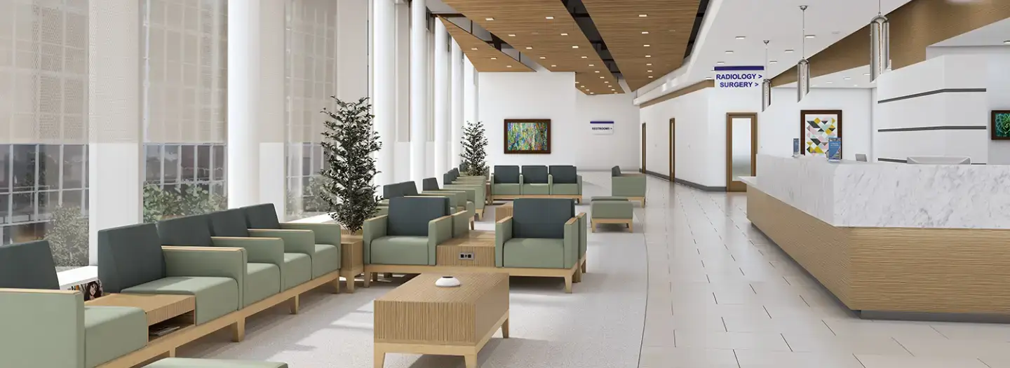 Modern healthcare waiting room with light wood and green upholstered lounge seating, integrated power outlets, ottomans, coffee tables, large windows, and reception desk for patient check-in and comfort.