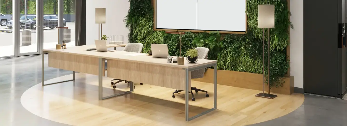 Modern hospitality reception area with light wood L-shaped desk, boucle task chairs, living green wall, floor lamps, and polished concrete floors for boutique hotel or retail management workspace.