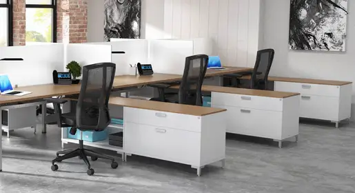 Sleek Blade office benching systems pod with frosted glass dividers, wood laminate worksurfaces, nd under-desk open storage and filing for space-optimizing collaborative workstations