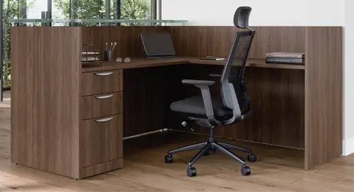 Clean-lined COE dark wood laminate front desk with frosted glass transaction top and box/box/file pedestal storage for efficient budget-friendly lobby setups