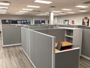 Remanufactured Knoll Morrison workstations with 56H bold grey panels, maple laminate surfaces, and ergonomic task chairs set up in a large open office space. Cost-effective solution for outfitting entire office floors quickly.