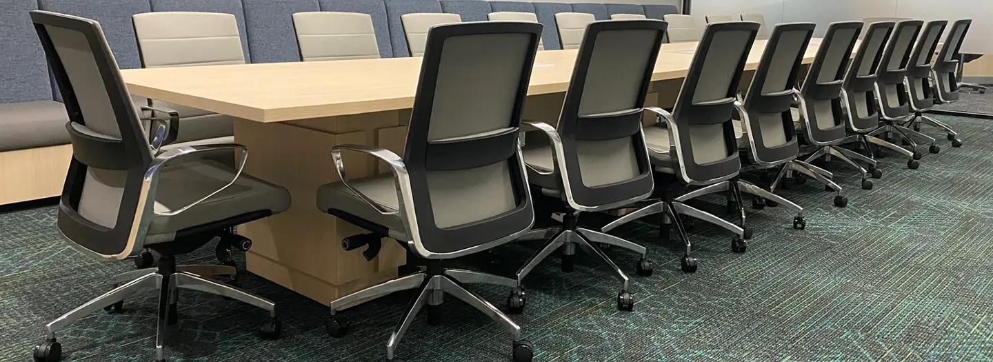 Another Office Furniture Connection project, this large conference rooms has a light wood laminate table that seats 20 in comfortable yet sleek conference chairs with chrome arms and bases.