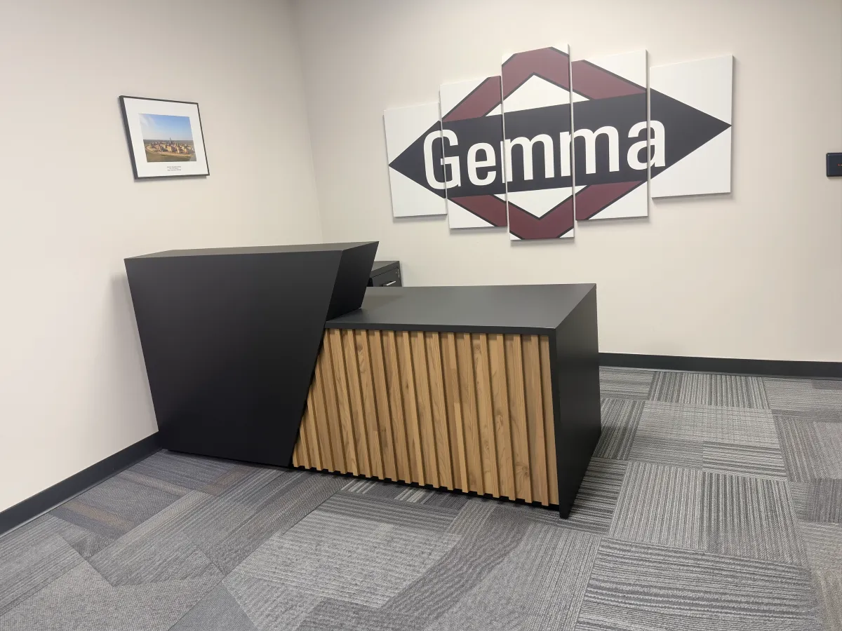 Striking black and oak wood slat reception desk from OFC CONNECT Series with angled transaction counter and modern geometric design – bold contemporary front office statement furniture by Office Furniture Connection Houston TX.