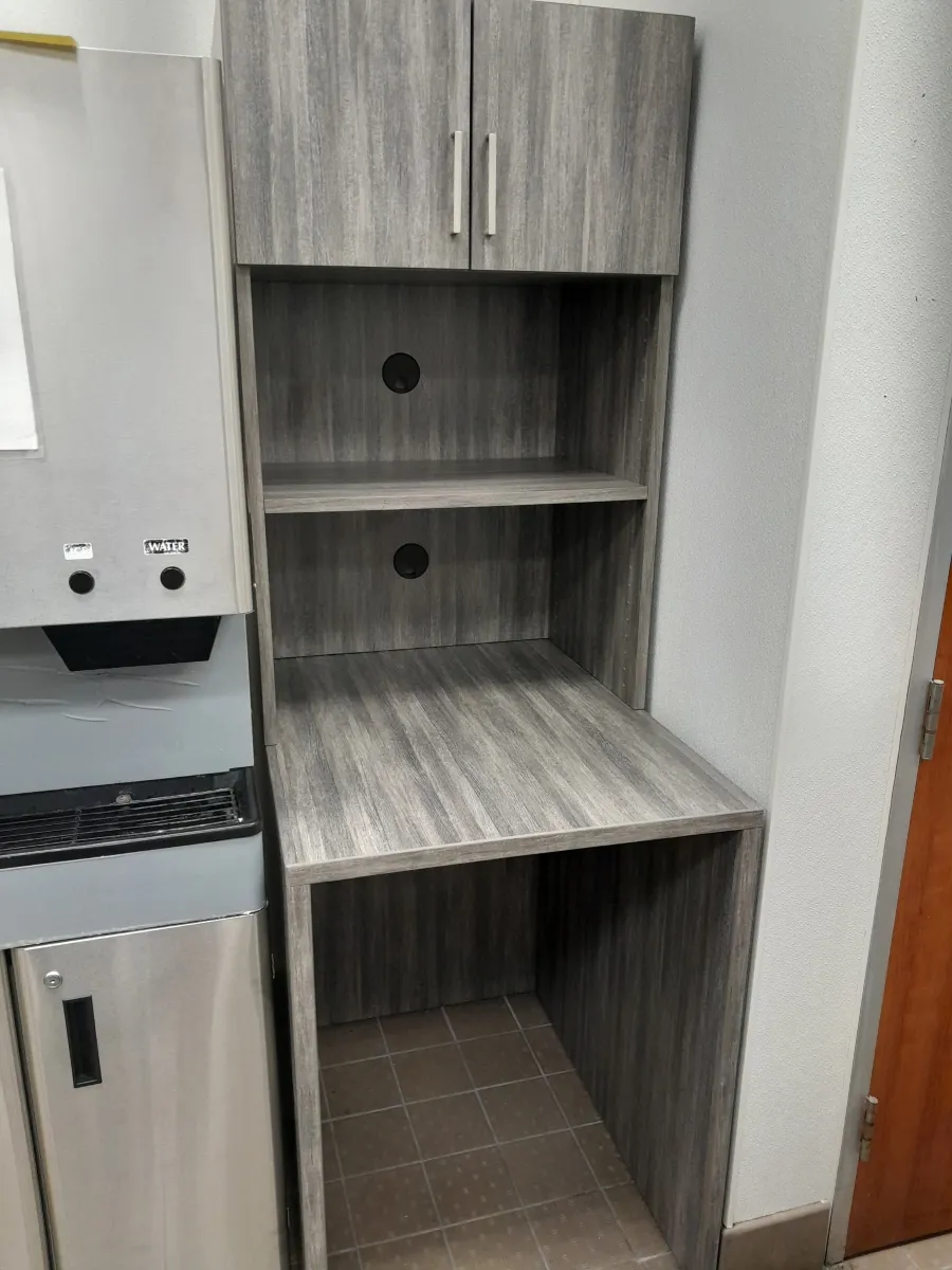 Gray wood laminate breakroom appliance garage from OFC CONNECT Series with overhead cabinet, open shelving, cord management holes, and laminate countertop – compact office coffee station and storage hutch by Office Furniture Connection Houston TX. (147 characters)