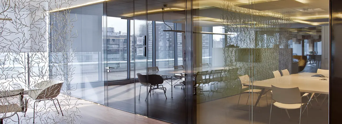 HERO: MetWall floor-to-ceiling frameless glass architectural walls defining three modern conference rooms in open office setting with contemporary furniture for flexible hybrid meeting spaces