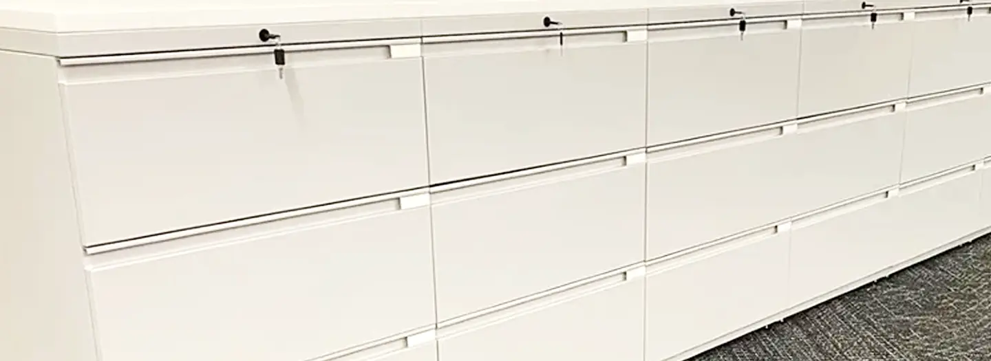 A bank of cream remanufactured Knoll series 2 three-high lateral files with locks