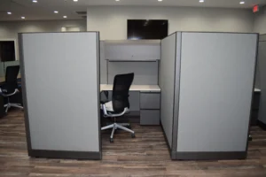 Remanufactured Knoll Morrison workstations with 64"h gray panels, white laminate worksurfaces, overhead storage with tasklight, and black ergonomic task chair with chrome base for maximum privacy in open office planning.