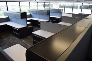 View from above of multiple remanufactured Knoll Morrison cubicles with 64"h blue panels with lockable storage, 42" gray panels to maximize natural light, lateral file and upholstered mobile ped.