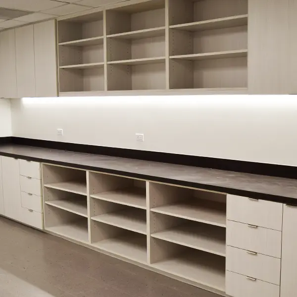New CONNECT series laboratory storage wall with open shelving, drawers, upper cabinets, and long black countertop in clean industrial workspace – new lab casework and storage furniture for sale Houston TX at Office Furniture Connection.