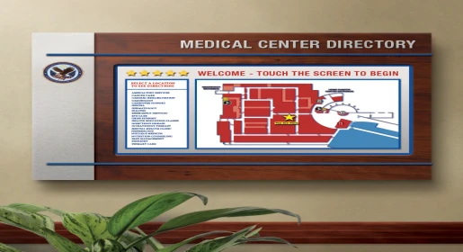 Large wood-framed medical center directory with interactive touch screen map, department listings, and wayfinding graphics by 2-90 Digital Signage– professional lobby and healthcare facility directional signage by Office Furniture Connection Houston TX.