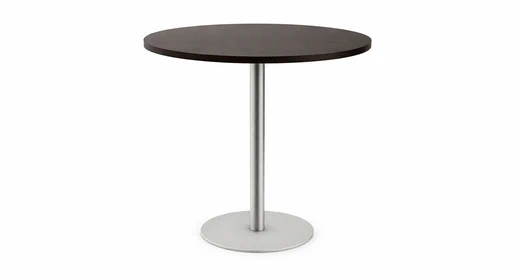 Contemporary round table with a dark wood-grain laminate top and a round metal base, displayed on a plain white studio background. Perfect for breakroom or dining areas or as a small office table for meetings in offices.