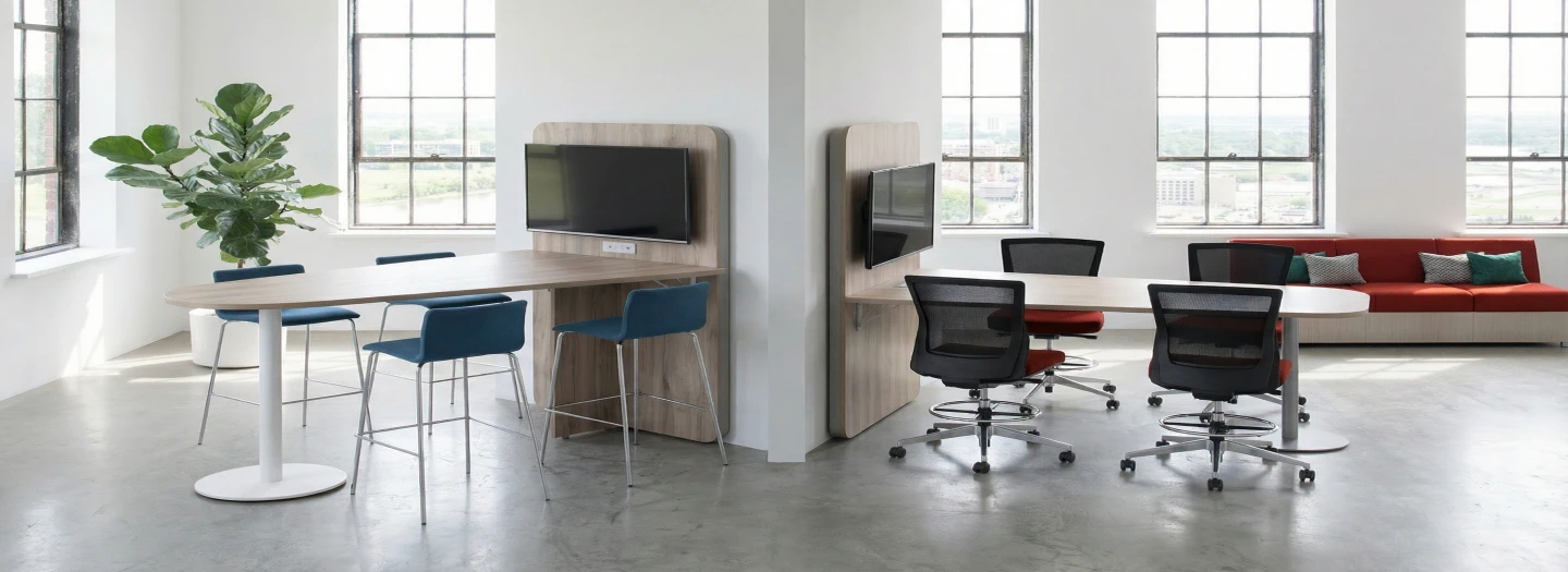 Back to back images of media tables with digital screen, poiwer and data integrated wall panel with digital screen and seating for 4 in bright open conferencing areas. Contact OFC for all of your office table needs.