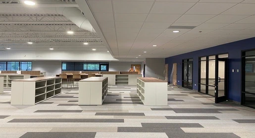 Sleek cream and gray metal lateral filing cabinets and storage units with lockable drawers arranged in a contemporary office setting – durable and functional solutions that pair seamlessly with OFC's remanufactured office furniture and cubicles, new office furniture, premium pre-owned furniture, and office filing and storage.