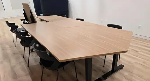 OFC's CONNECT conference tables with clean-lines, laminate flip-top surfaces and durable finishes set in a modern, light-filled collaborative workspace, ideal for meetings and teamwork, seamlessly supporting OFC’s remanufactured, new, and pre-owned furniture solutions. OFC's CONNECT Series offers conference tables as well as cafe, collaboration, media, occasional, and training tables for clients in Houston, TX