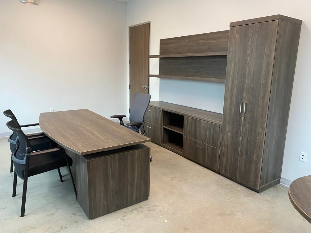 Dark walnut laminate private office with bow-front desk, credenza wall unit and wardrobe