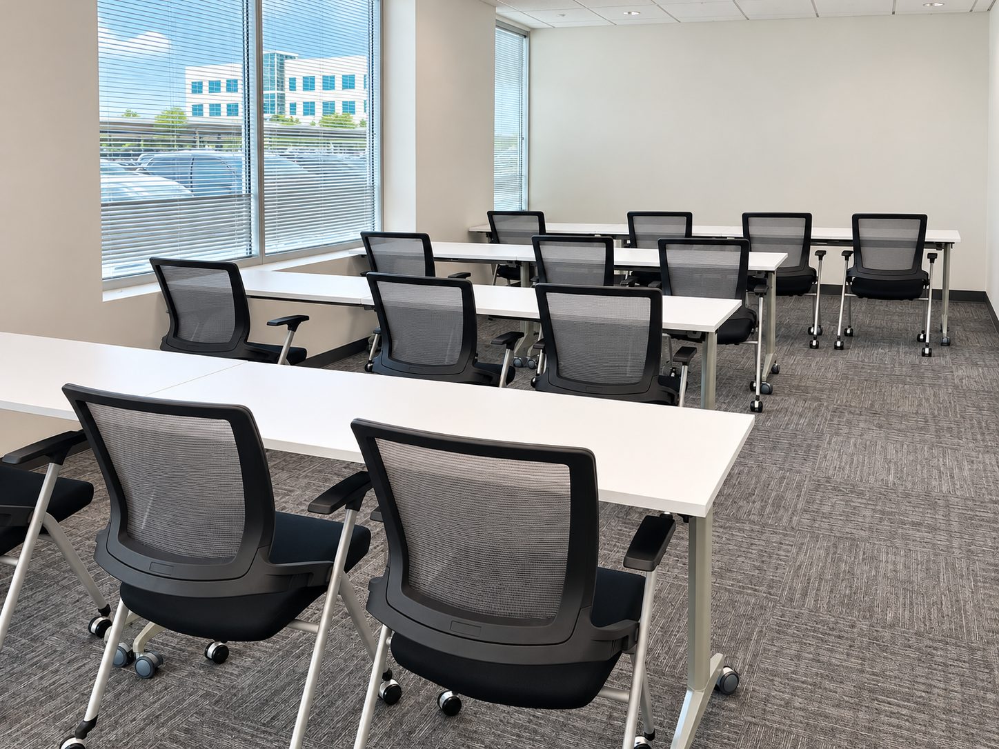 Training room with flip-top training tables and mesh nesting chairs at RPT Alliance, Houston