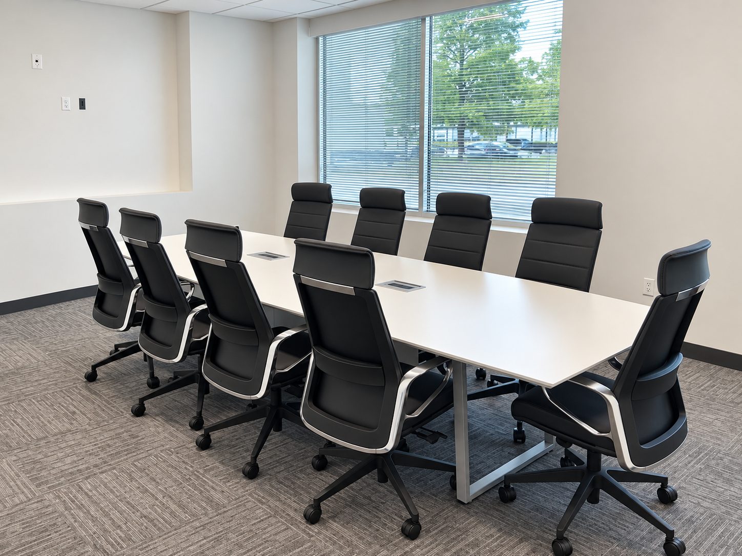 Large conference room with white conference table and high-back conference chairs at RPT Alliance