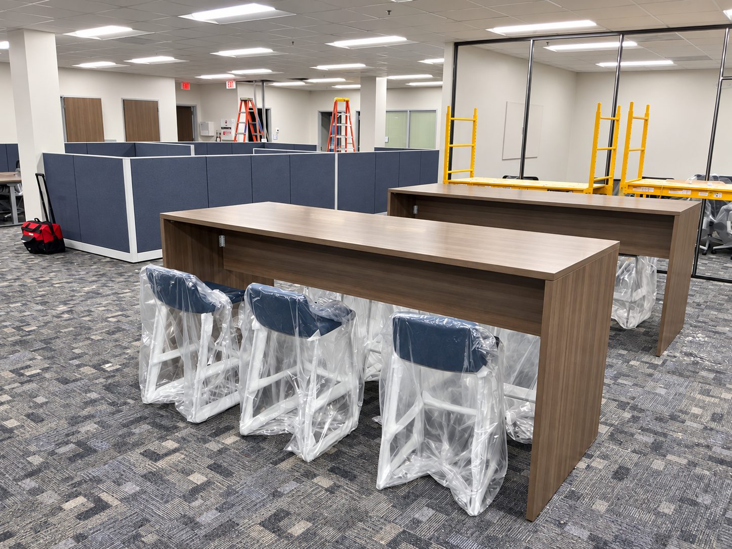 Parsons-height collaboration table with stools installed while construction was underway