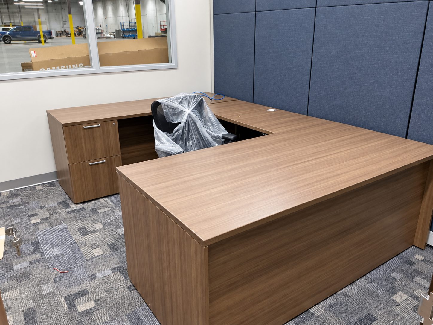 Private office with U-shaped desk and task chair at Bayou Electrical, Houston