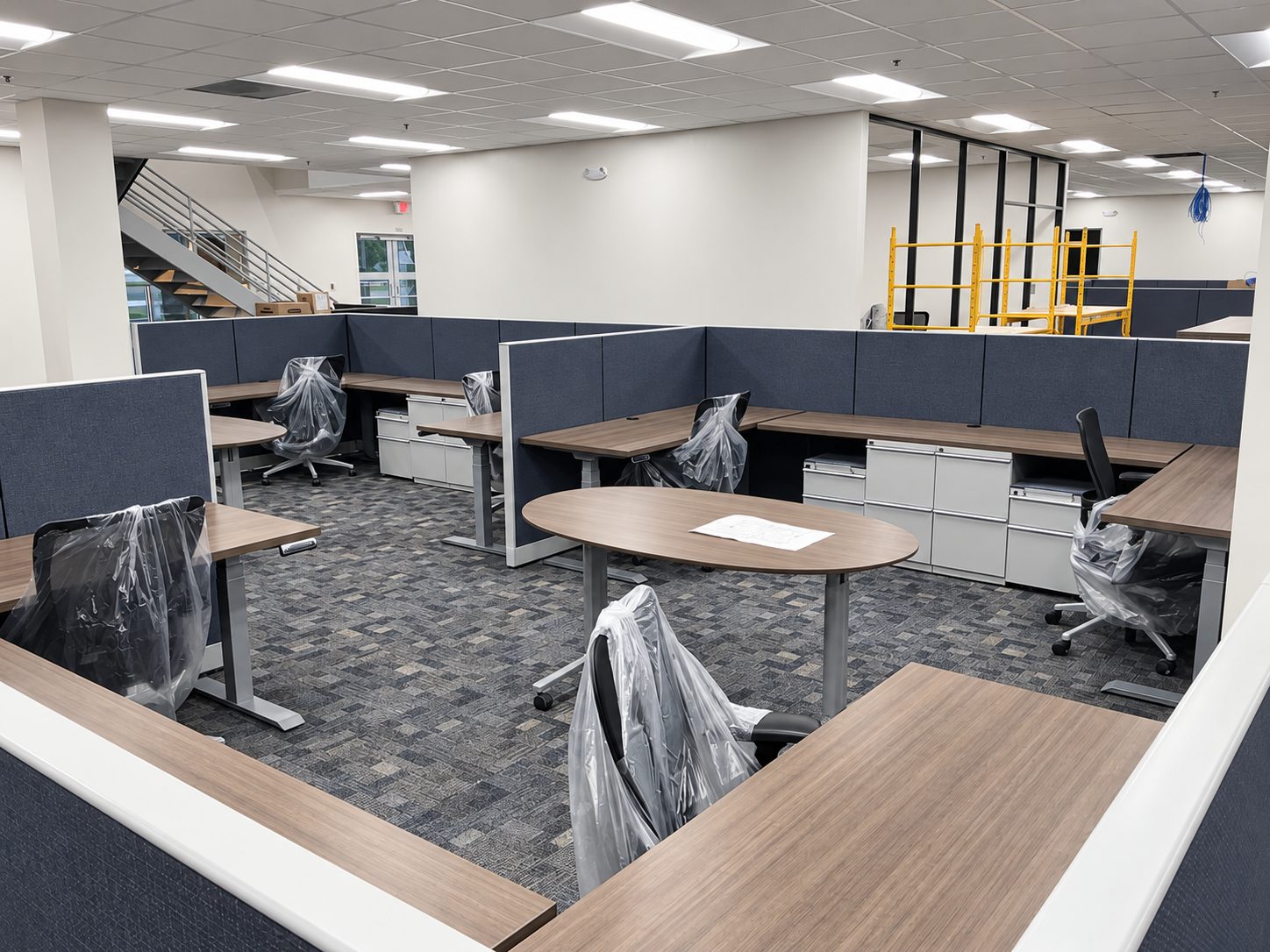 Open office workstations with oval meeting table at Bayou Electrical