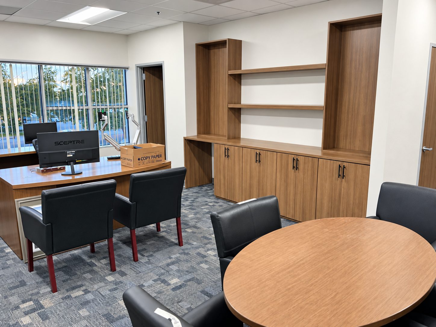 Executive office with custom built-in cabinetry by VOIS woodshop and leather guest chairs