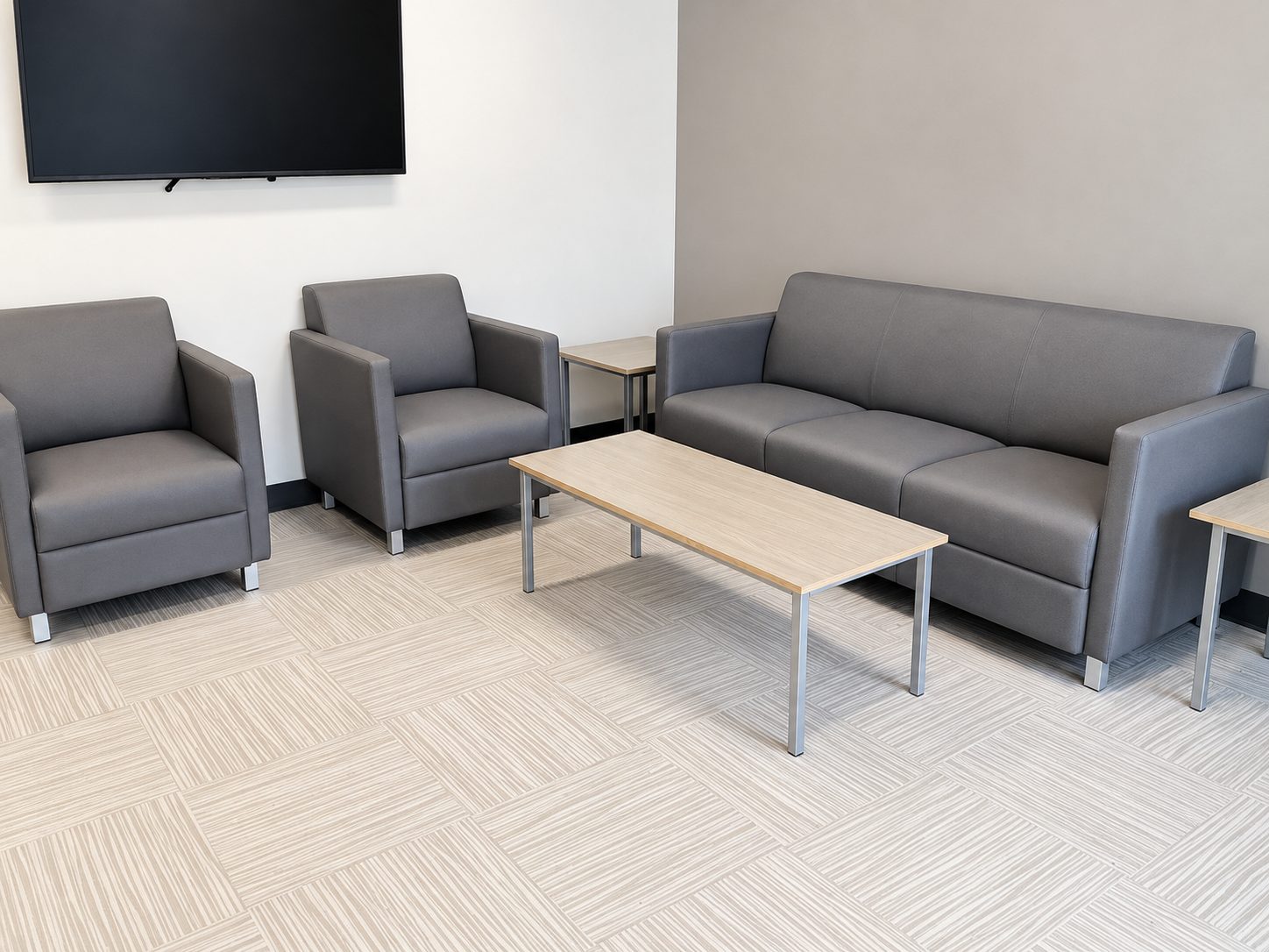 Lounge area with sofa, club chairs and coffee table at Rice University Police and EMS annex