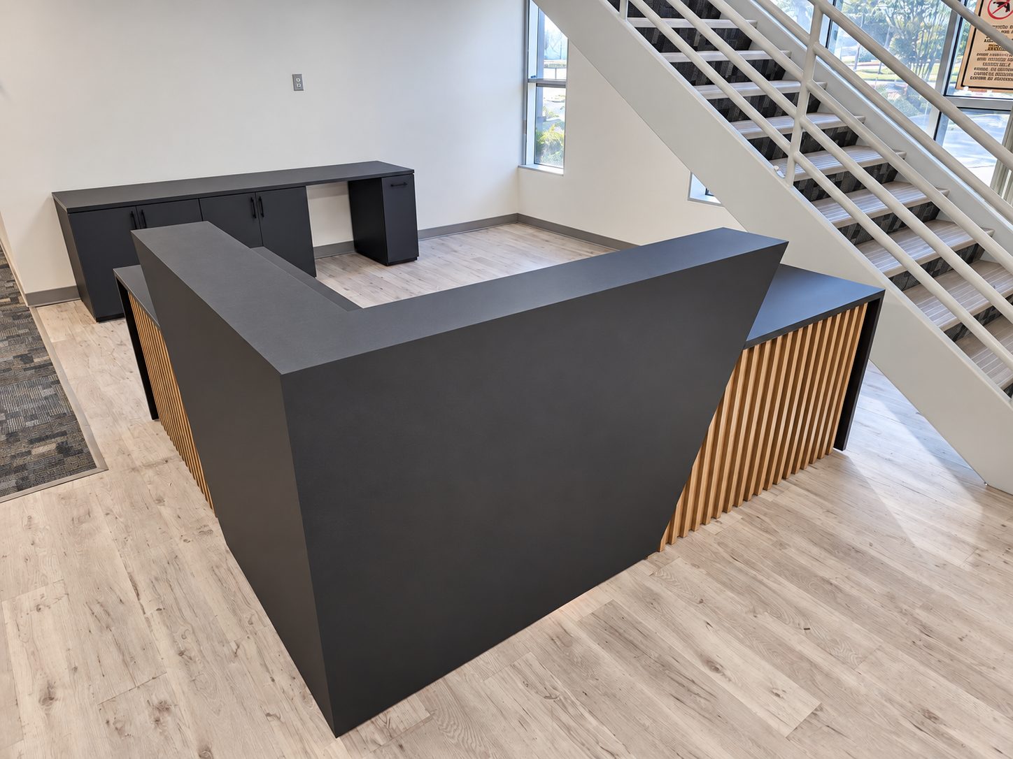 Custom reception desk with wood slat detailing built by VOIS woodshop, overhead view