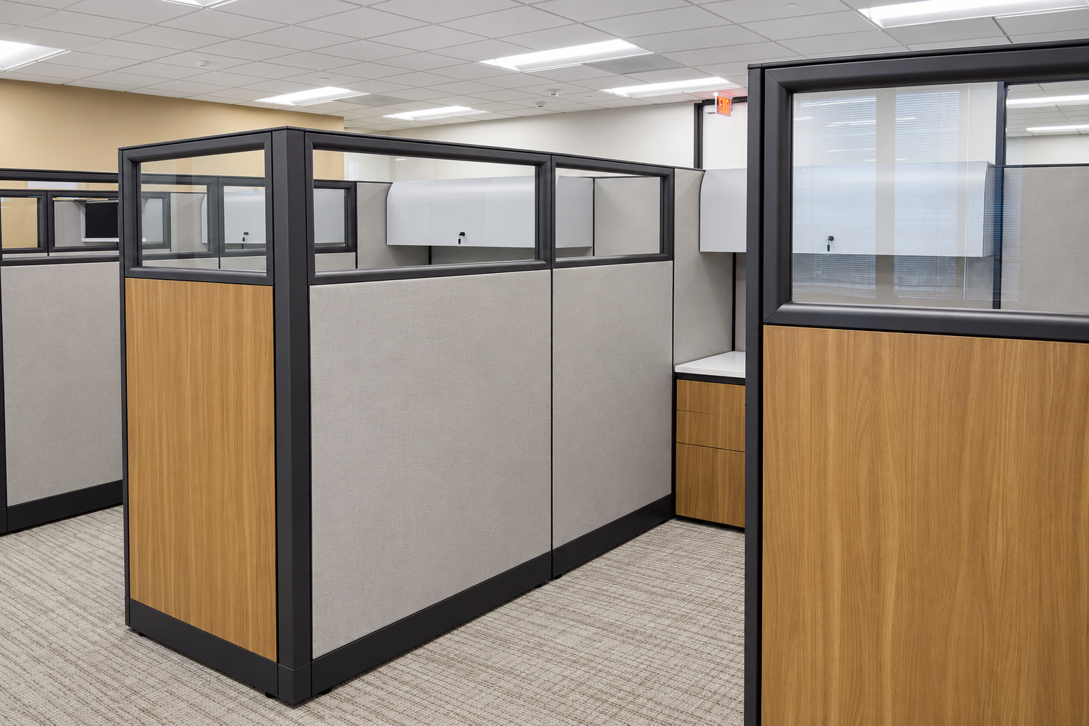 Houston law firm workstations with gray panels, black frames, glass upper panels, and wood finish accents.
